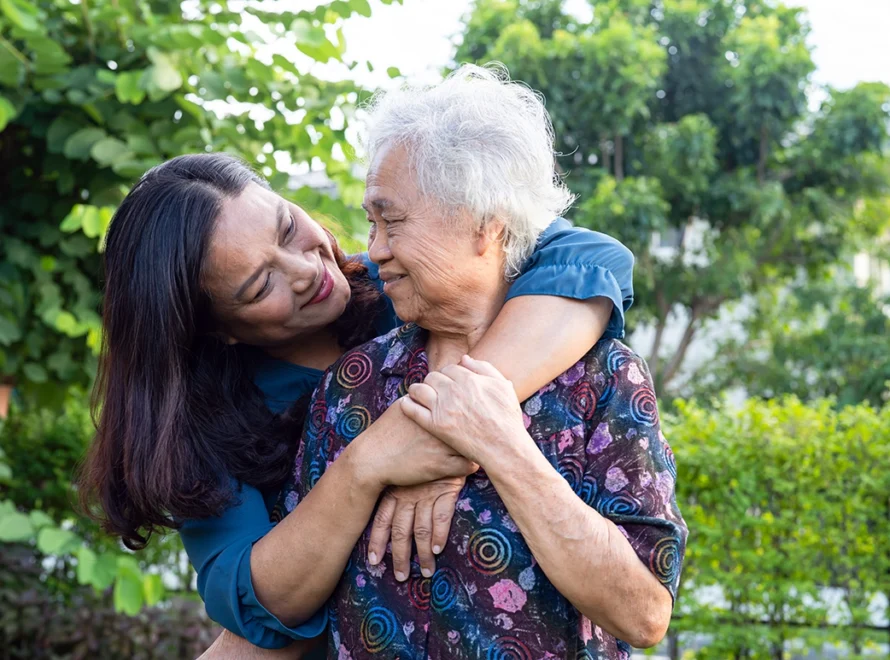 elderly woman hugging her daughter
