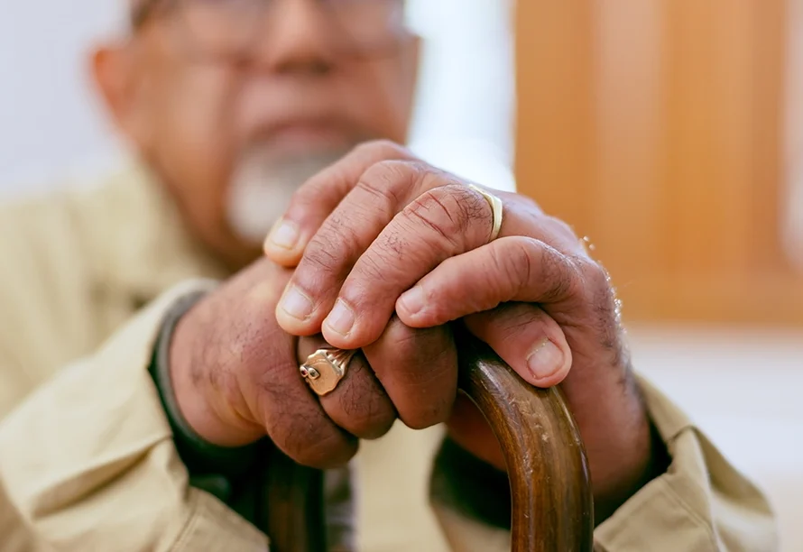 elderly man holding his cane