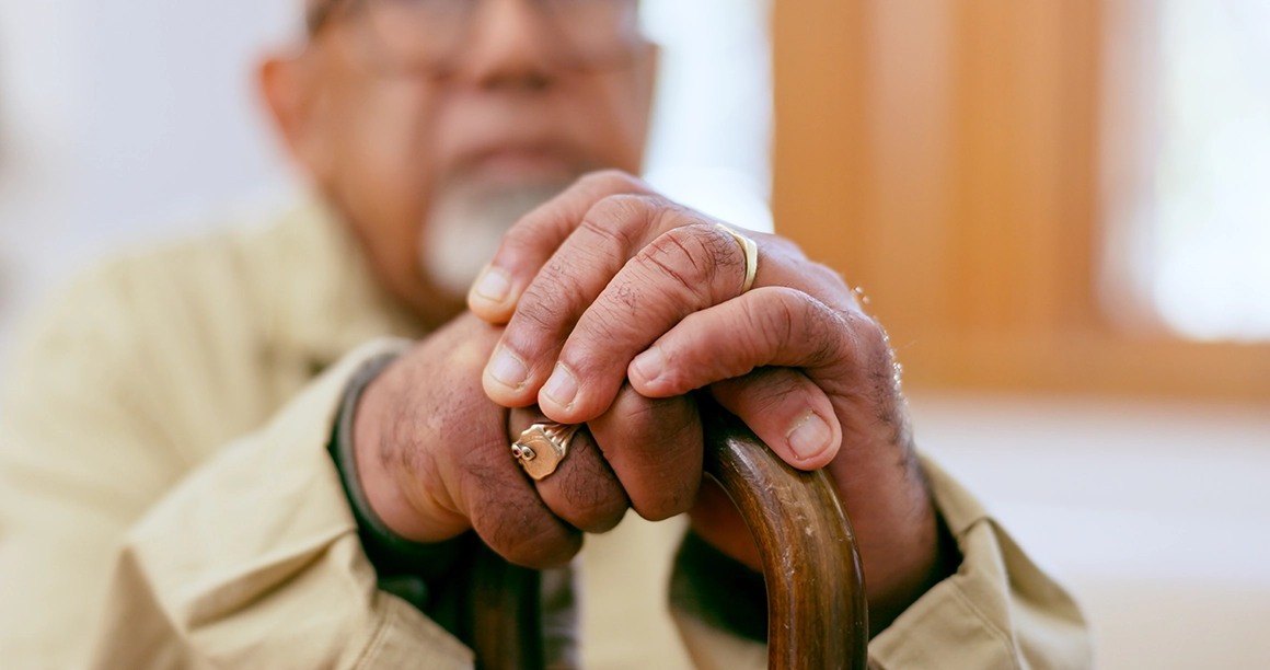 elderly man holding his cane