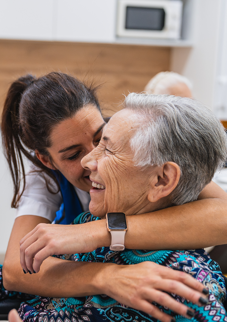 caring-nurse-embracing-elderly-woman-in-nursing-home A caring nurse embracing an elderly woman in a nursing home.