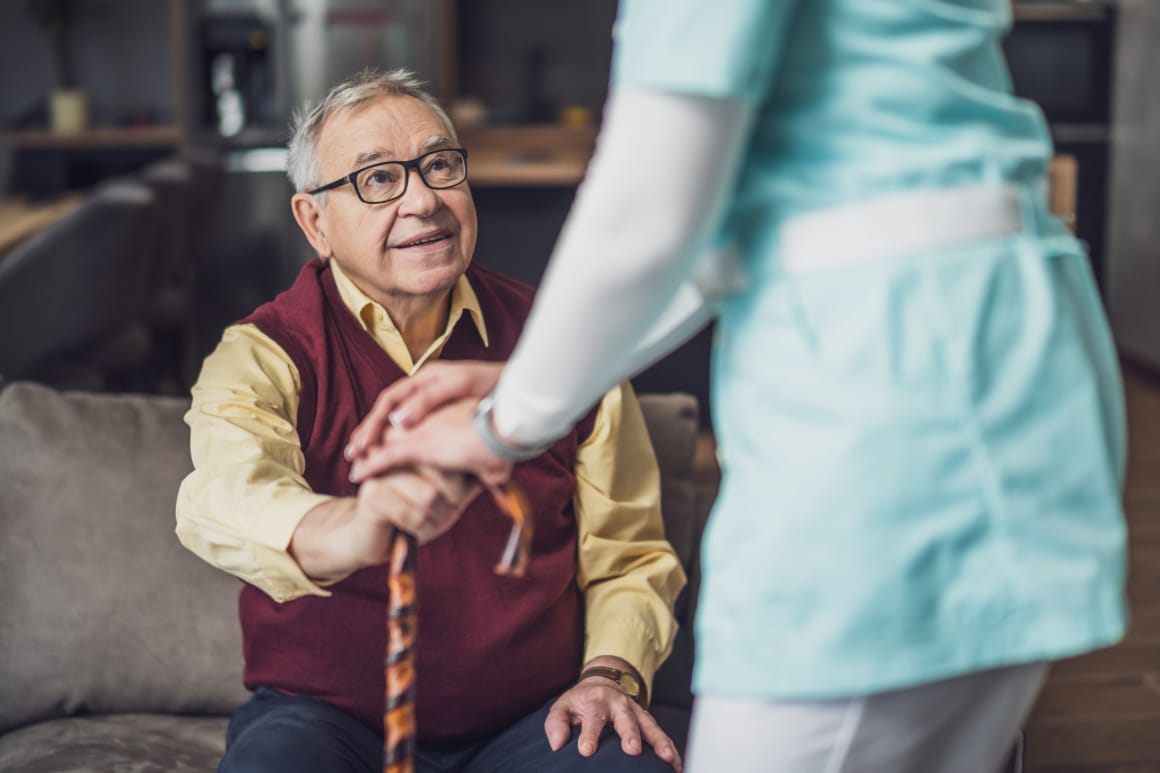 An elderly man and his caregiver.